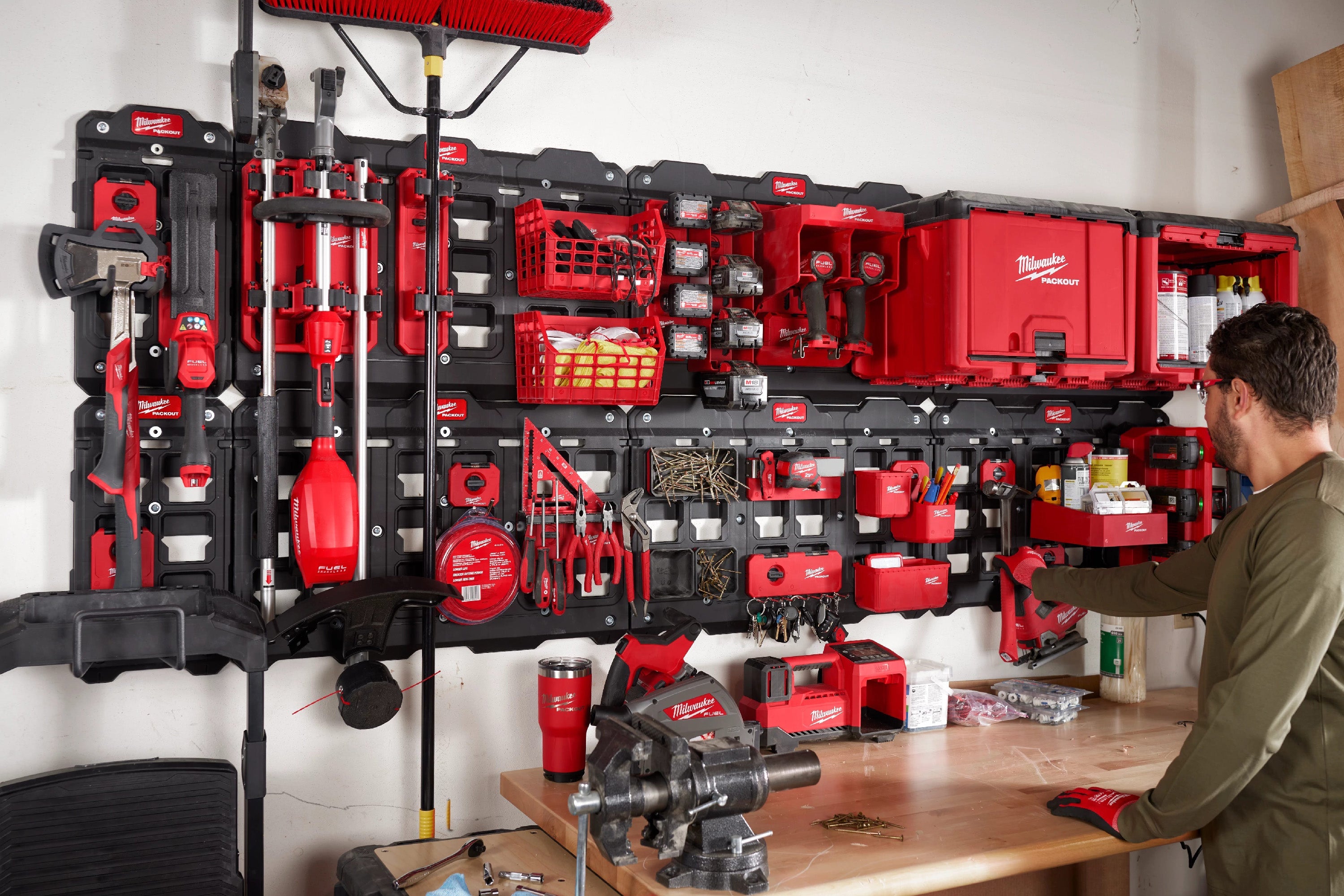 A man infront of the Milwaukee PACKOUT Shop Storage Mounted tools